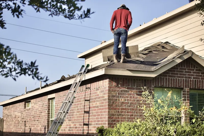 Professional roofer working on a residential roof in Berlinsville